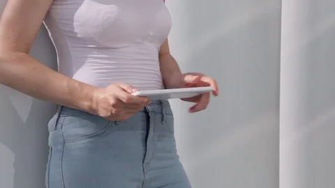 Young woman multitasking on tablet computer, outdoor in the sunny city Stock Footage 72348332