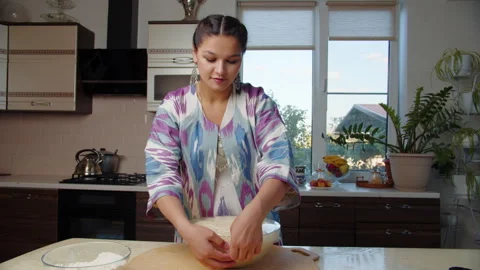 Young woman opening risen dough Stock Footage 317528748