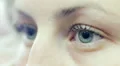 Young woman opens and closes her eyes - macro HD Footage