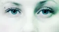 young woman opens and closes her blue eyes - macro HD Footage