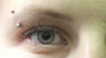 young woman opens and closes her blue eyes - macro HD Footage