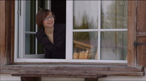 Young woman opens the window  outside Video stock 40690404