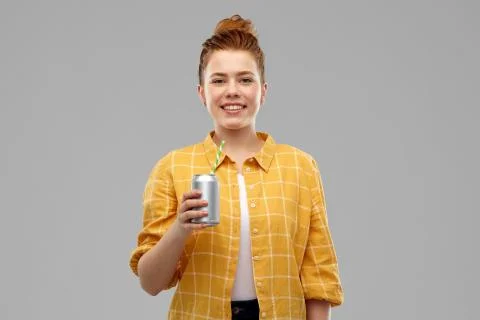 Young woman or teenage girl drinking soda from can Stock Photos