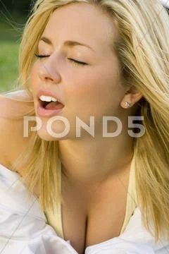 Young woman outside soaking up sunshine Stock Photos