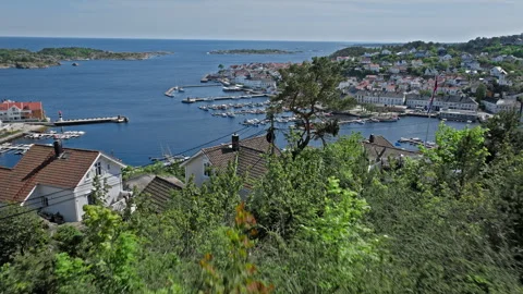 Young woman overlooking Risor Norway harbour from hillside viewpoint. Stock Footage 328126547