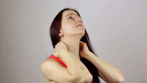 Young woman with pain in the neck joint Stock Footage