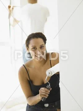 Young woman painting her house Stock Photos