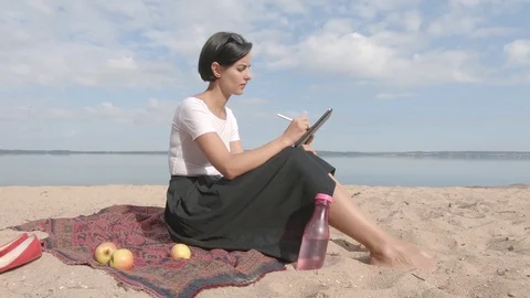 Young Woman Paints On Graphic Tablet Computer Near Beautiful Lake Stock Footage