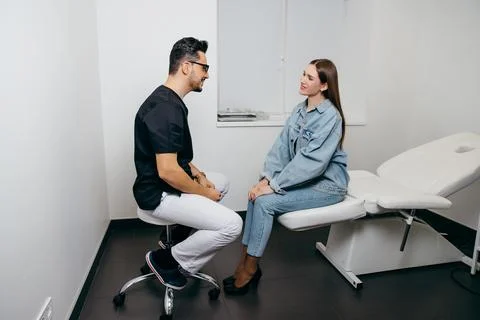 Young woman patient have consultation with doctor before exam Stock Photos