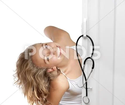 Young woman peeking through door Stock Photos