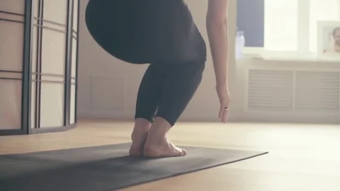 A young woman performing yoga-asanas Stock Footage