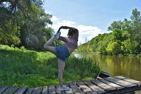 A young woman performs an exercise. Stock Photos
