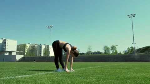Young woman performs standing toe touches Stock Footage 64307215