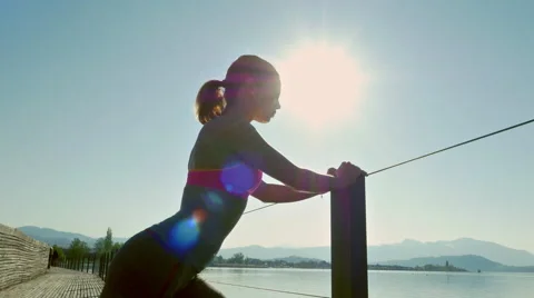 Young woman performs strectches Stock Footage 63890647