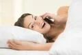 The young woman phone on the bed Photo
