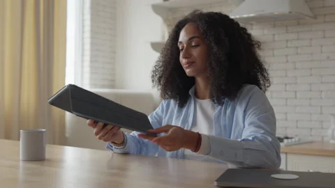 Young Woman Picks Up E-Reader And Starts Reading, Relaxing Moment At Home 스톡 동영상 302451682