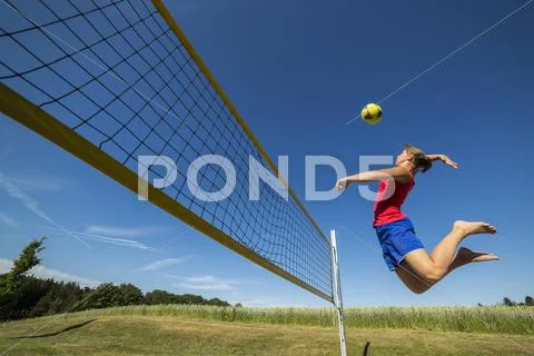 Young Woman Playing Beach Volleyball
