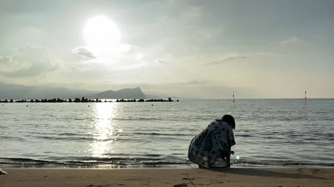 A young woman playing at the beach while seagulls flying across the sea Stock Footage 137070733