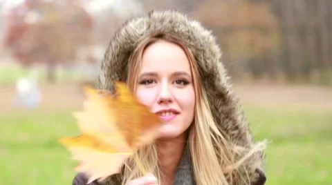 Young woman playing with leaf Stock Footage 59554412