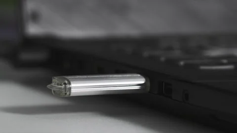 Young woman plug usb flash drive into connector on computer, close-up Stock Footage 240859629