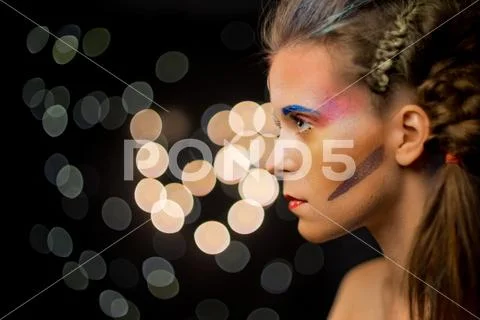 Young woman portrait, multicolor face painting. Model with make up. Girl with Stock Photos