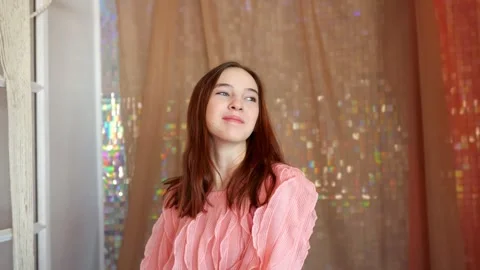 Young woman posing and touching hair in pink dress Stock Footage 330107014