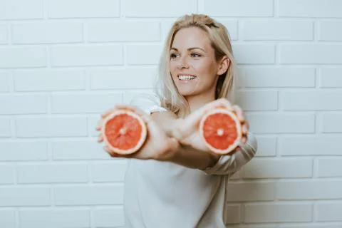 Young woman posing in front of a white brick background Stock Photos