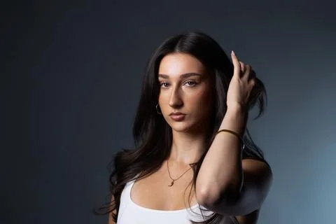 Young woman posing looking at camera in studio Stock Photos