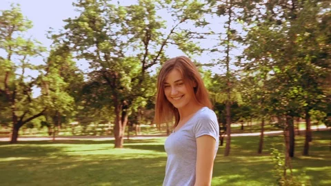 Young woman posing smiling to the camera outdoors Stock Footage 127845150