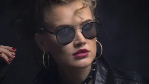 Young woman posing in sunglasses, blode curl on her forehead Stock Footage 101583979