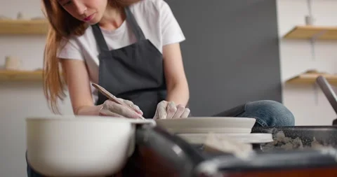 Young woman in pottery studio using pottery wheel, handmade ceramics, creative Stock-Footage 155357829