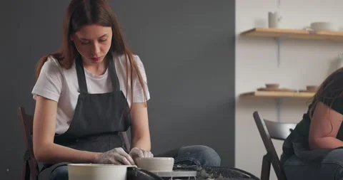 Young woman in pottery studio using pottery whee. Slow motion Stock Footage 155997446