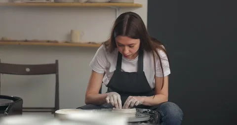 Young woman in pottery studio using pottery whee. Slow motion Stock Footage 164688486