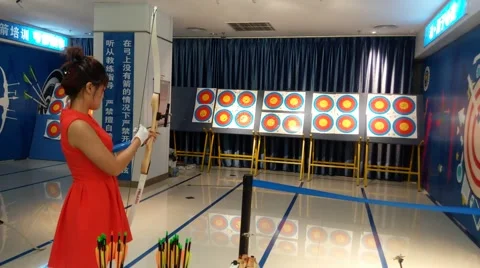 Young woman practicing archery Stock Footage