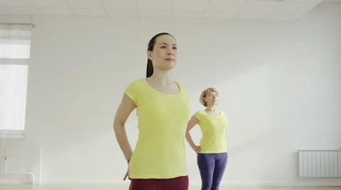 Young woman is practicing the Eagle Pose Stock Footage 62276035