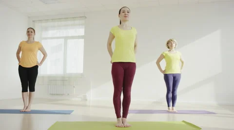 Young woman is practicing the Eagle Pose Stock Footage 62301656