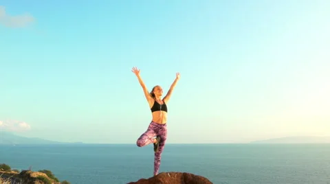 Young Woman Practicing Yoga in Nature. Reaching the Top. Mountian View at Sun Stock Footage 59031152