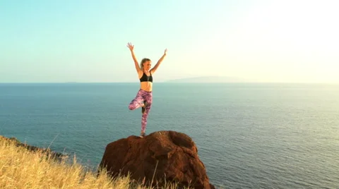 Young Woman Practicing Yoga in Nature. Reaching the Top. Mountian View at Sun Stock Footage