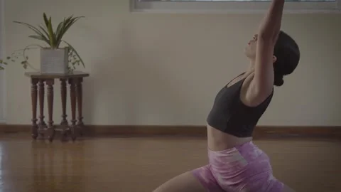 Young woman practicing a yoga routine at home Stock-Footage 343195211