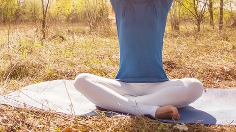 Young woman practicing yoga in a spring forest. Video stock 80559742