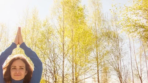 Young woman practicing yoga in a spring forest. Stock Footage 80562953