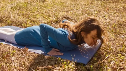 Young woman practicing yoga in a spring forest. Stock Footage