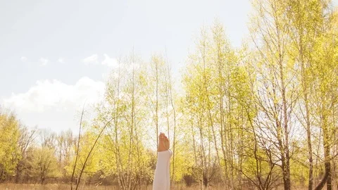 Young woman practicing yoga in a spring forest. Video stock 80610294