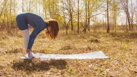 Young woman practicing yoga in a spring forest. 스톡 동영상 80615186