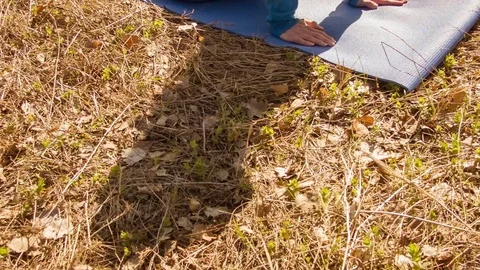 Young woman practicing yoga in a spring forest. Vídeo Stock 80618675