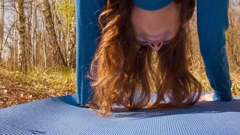 Young woman practicing yoga in a spring forest. Video stock 80621557