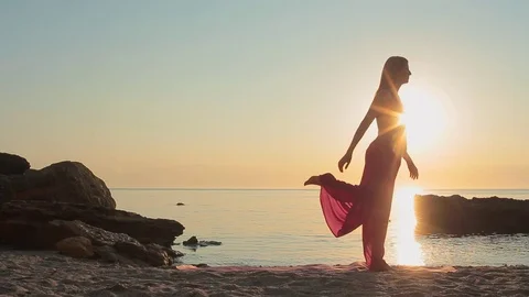 Young woman practicing yoga at the sunrise Stock Footage