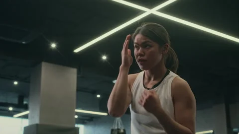 Young Woman Practising Shadow Boxing Alone at Gym Stock Footage 277558301