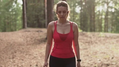 Young woman preparing to jog, starts a workout tracking on a smart watch and Stock Footage