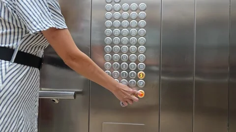 Young woman presses a button in the elevator Stock Footage 277317918